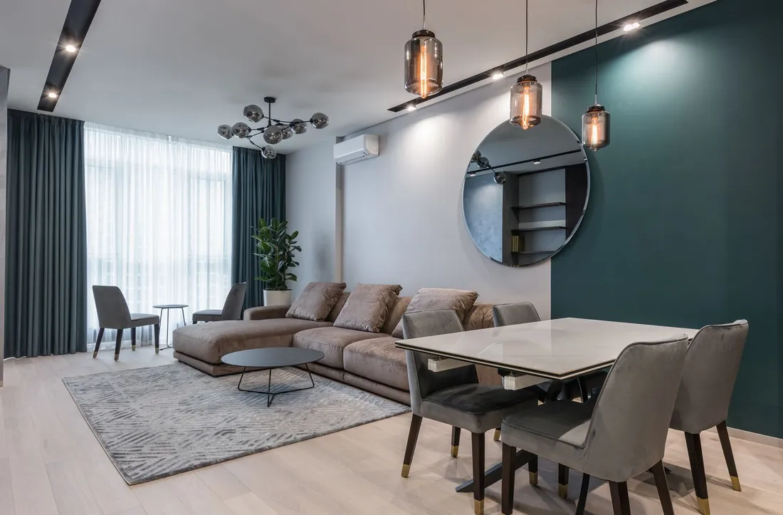 Sejour d'un appartement meuble moderne avec canape, table a manger et coin repas