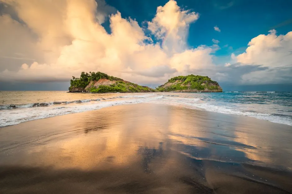 Plage de sable de Sainte-Marie en Martinique au coucher du soleil avec les ilots et un ciel ensoleille de saison seche