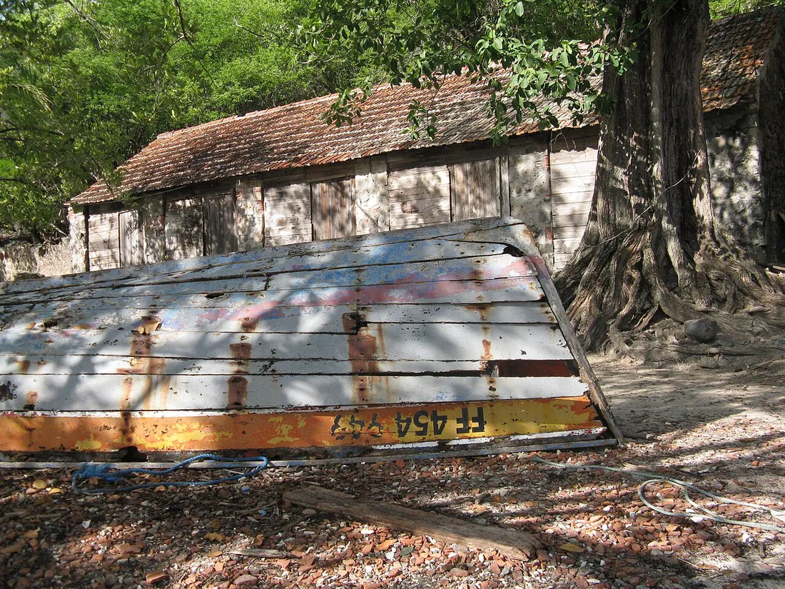 Ancienne barque et cabanon en bois à l'ombre des arbres sur l'îlet Chancel, dans la baie du Robert en Martinique